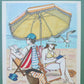Un couple est installé sous un grand parasol jaune à la plage, entre lecture et cahier de jeux, œuvre originale d’Ana Jarén.