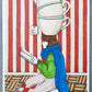 Une femme lit à genoux tandis que quatre tasses de thé s’empilent en équilibre au-dessus d’elle, œuvre originale d’Ana Jarén.